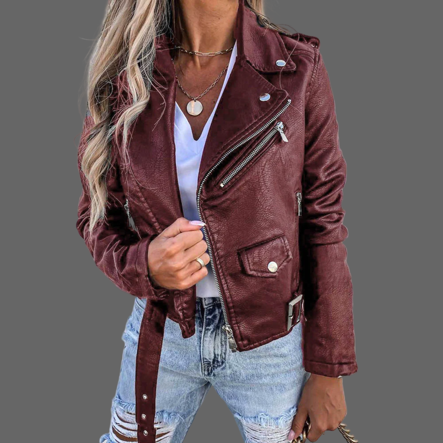 Dames leren jas gemaakt van premium leer, met een stijlvol design inclusief taille accentuerende riem. Verkrijgbaar in trendy rood en zwart, en geschikt voor diverse gelegenheden. Maattabel beschikbaar voor de juiste pasvorm.